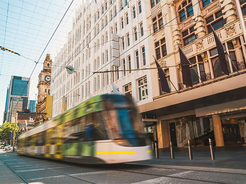 Bourke St Mall with tram passing through frame.
