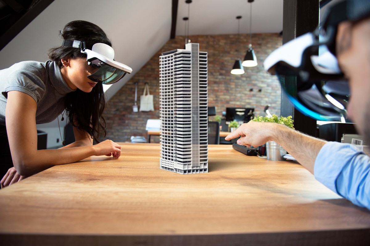 woman and wearing virtual reality lens looking at a 3d digital building model